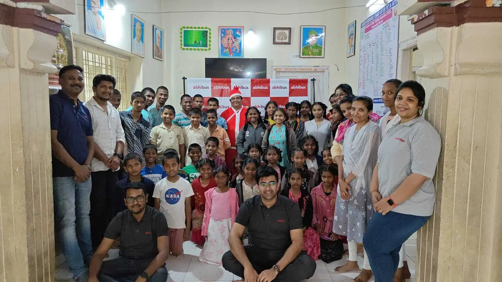 AbhiBus team with children at a CSR event