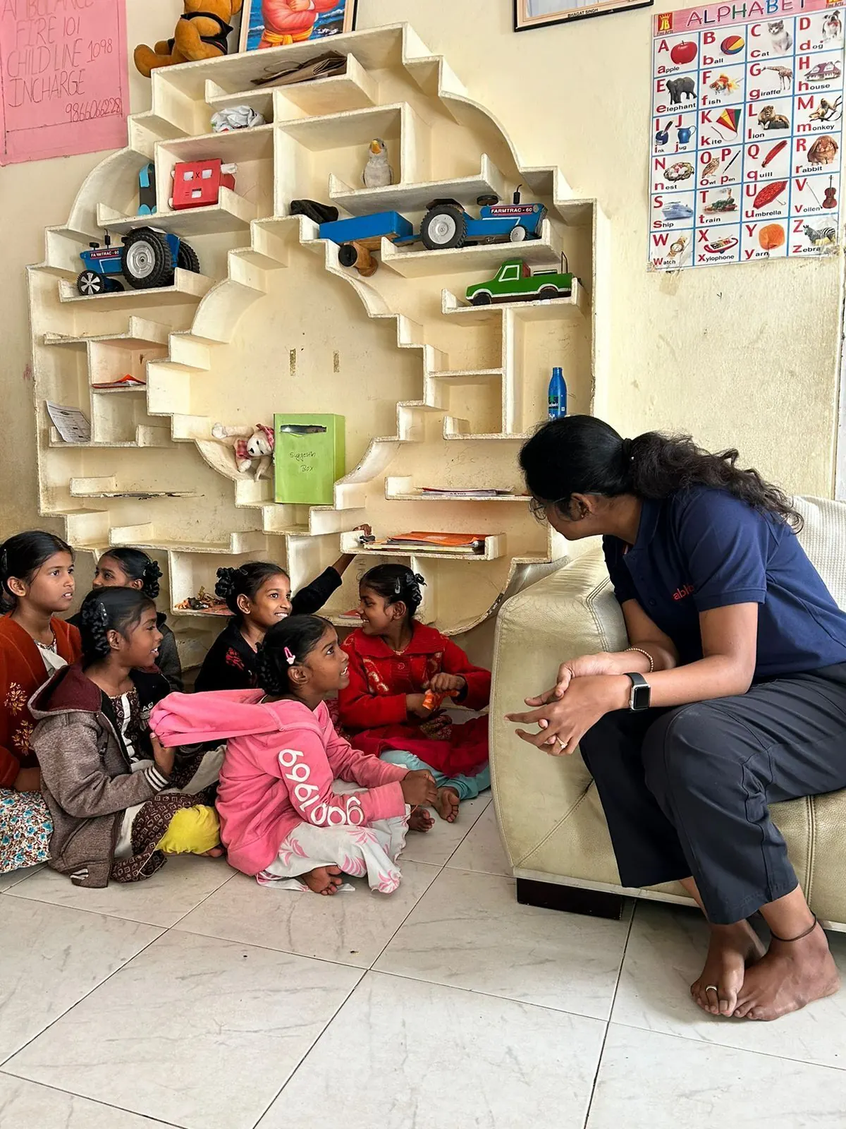 AbhiBus CSR volunteer speaking with children